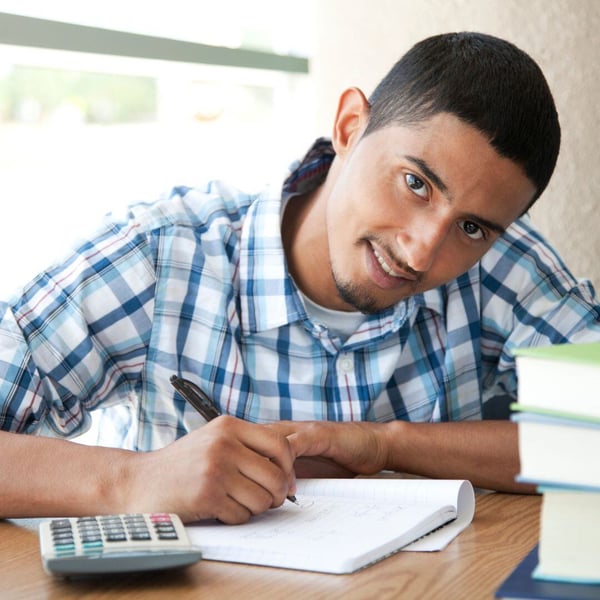 Student completing math problems in workbook